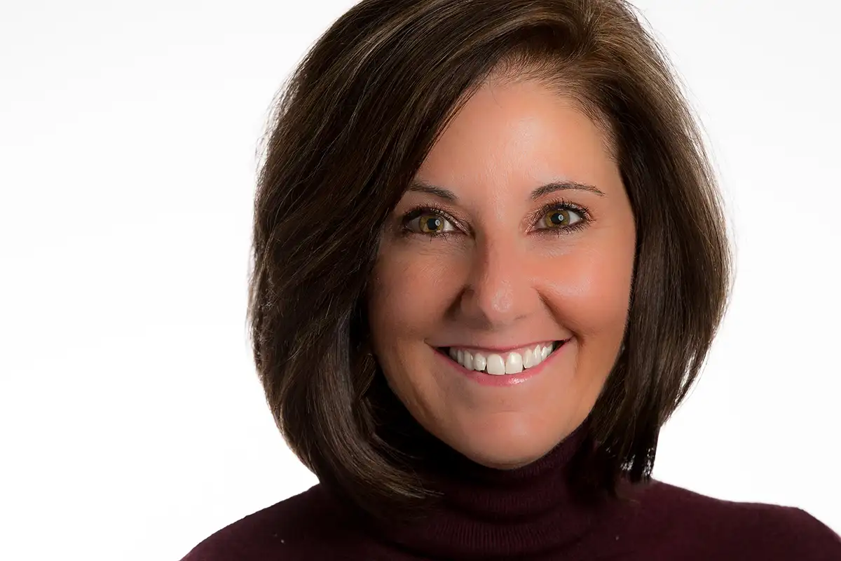 Professional studio headshot of Jennifer Holmes, CEO, on white background